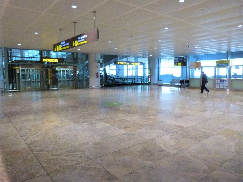 Alicante airport lifts and escalator down to shuttle transfer desks